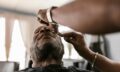 A serene moment during a beard trim in a barbershop, featuring skilled hands and focused attention.