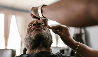 A serene moment during a beard trim in a barbershop, featuring skilled hands and focused attention.