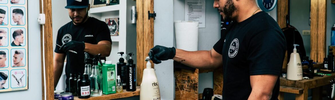 A barber in a stylish shop preparing tools for a haircut. Modern interior design with mirrors and grooming products.