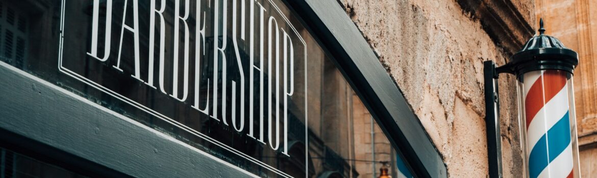a barber shop sign on the side of a building
