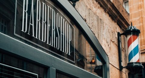 a barber shop sign on the side of a building