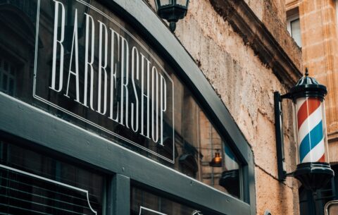 a barber shop sign on the side of a building