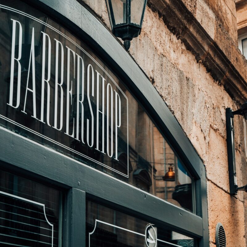 a barber shop sign on the side of a building